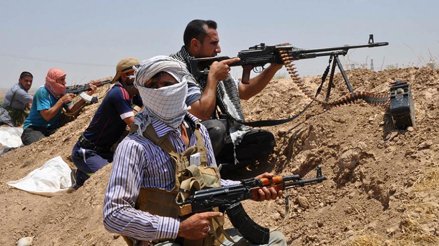 Iraqi Shi'ite Turkmen fighters take part in an intensive security deployment in the town of Taza, south of the northern oil city of Kirkuk, June 19, 2014. The United States is contemplating talks with its arch-enemy Iran to support the Iraqi government in its battle with Sunni Islamist insurgents who routed Baghdad's army and seized the north of the country in the past week. REUTERS/Stringer (IRAQ - Tags: CIVIL UNREST POLITICS) - RTR3UOZA