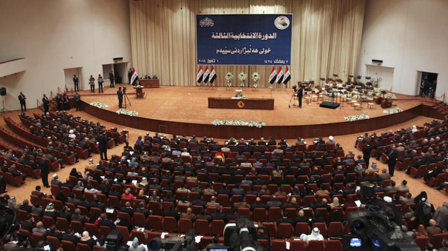 Members of the newly elected Iraqi parliament attend a session at the Parliament headquarters in Baghdad July 1, 2014. The acting speaker of Iraq's newly elected parliament said no agreement had been reached on naming a new speaker and that the parliament now had no quorum.    REUTERS/Stringer (IRAQ - Tags: POLITICS) - RTR3WLLU
