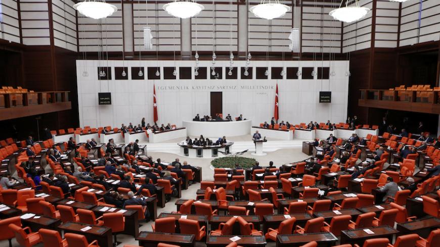 Turkish Parliament convenes to vote on a motion which would allow the government to authorise cross-border military incursions against Islamic State fighters in Syria and Iraq, and allow coalition forces to use Turkish territory, in Ankara October 2, 2014. REUTERS/Umit Bektas (TURKEY - Tags: POLITICS MILITARY CIVIL UNREST CONFLICT) - RTR48OUH