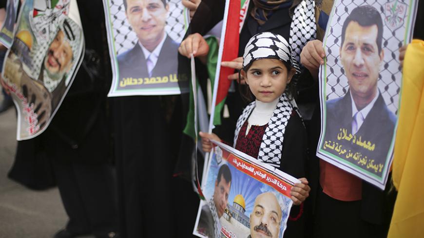 Palestinian supporters of former head of Fatah in Gaza, Mohammed Dahlan, hold posters depicting Dahlan (R) during a protest against Palestinian President Mahmoud Abbas in Gaza City December 18, 2014. Dahlan, who lives in exile in the Gulf, is a powerful political foe of Abbas.
REUTERS/Mohammed Salem (GAZA - Tags: POLITICS CIVIL UNREST) - RTR4IJ93