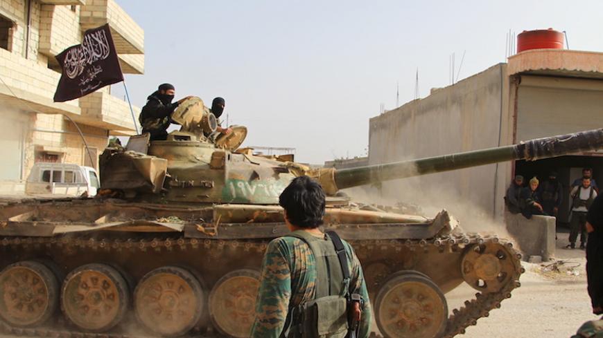 Members of al Qaeda's Nusra Front ride on a tank as they head towards their positions during an offensive to take control of the northwestern city of Ariha from forces loyal to Syria's President Bashar al-Assad, in Idlib province May 28, 2015. The Syrian army has pulled back from the northwestern city of Ariha after a coalition of insurgent groups seized the last city in Idlib province in northwestern Syria near the Turkish border that was still held by the government. REUTERS/Ammar Abdullah - RTR4XXNO