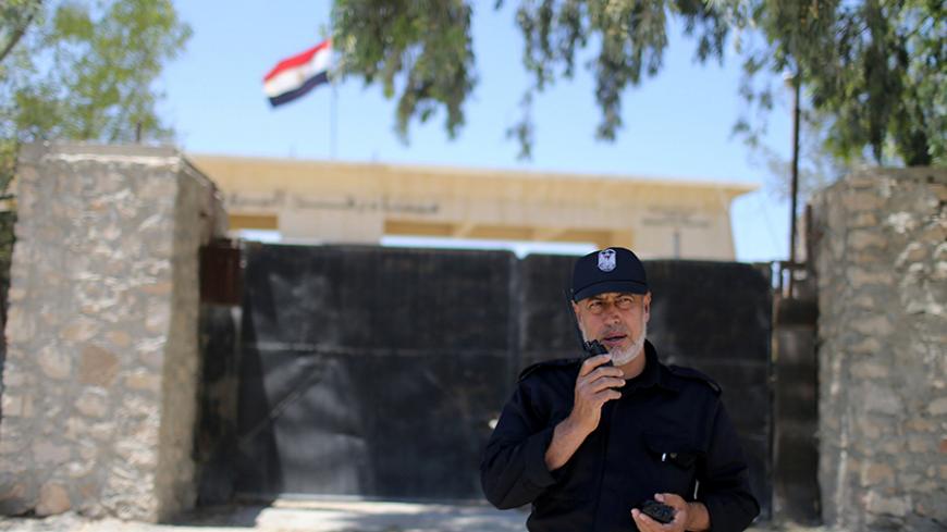 A member of the Palestinian security forces loyal to Hamas speaks on a walkie-talkie at Rafah border crossing between Egypt and southern Gaza Strip May 19, 2016. REUTERS/Ibraheem Abu Mustafa - RTSEZZG