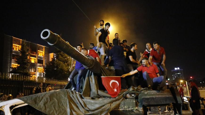 People stand on a Turkish army tank in Ankara, Turkey July 16, 2016. REUTERS/Tumay Berkin - RTSI7T9