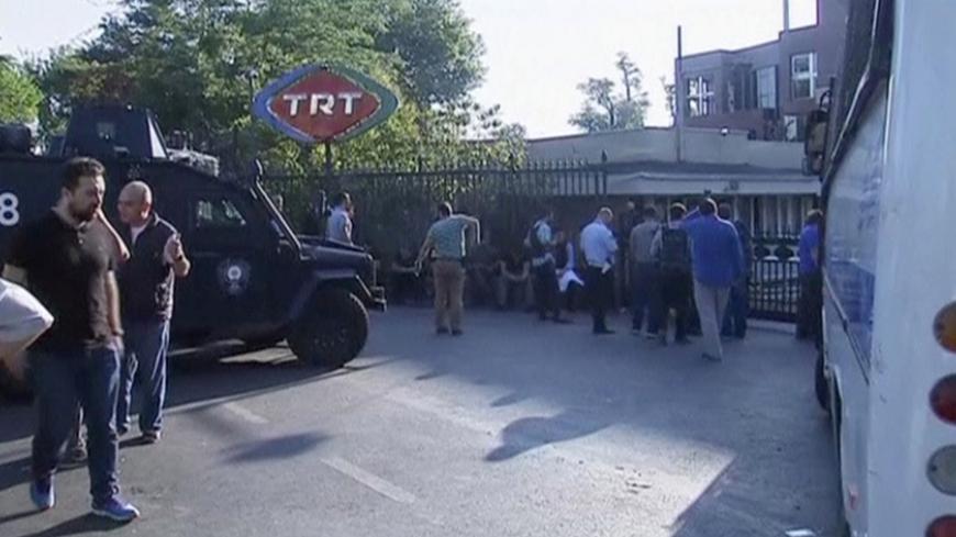 A still image from video shows armoured police vehicle and people waiting outside TRT state television after a failed coup attempt by Turkish soldiers, in Istanbul, Turkey July 16, 2016. REUTERS/via Reuters TV - RTSI8WB