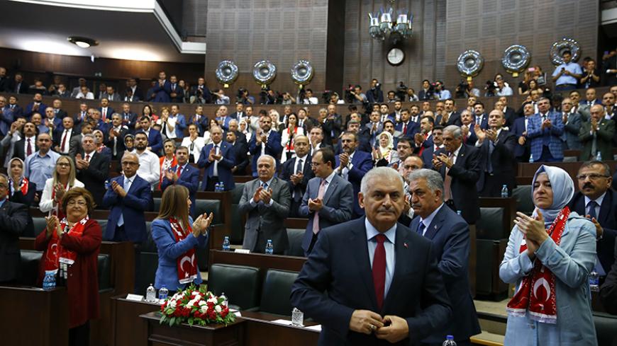 Turkey's Prime Minister Binali Yildrim (front) makes his way to address members of parliament from his ruling AK Party (AKP) during a meeting at the Turkish parliament in Ankara, Turkey July 19, 2016. REUTERS/Umit Bektas - RTSINN5