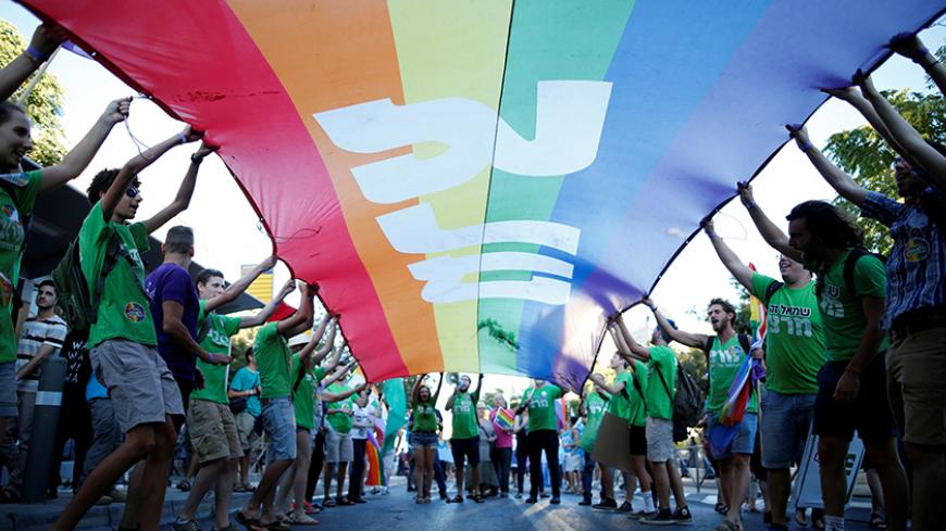 Participants take part in the annual Gay Pride parade in Jerusalem July 21, 2016. REUTERS/Amir Cohen - RTSJ32P