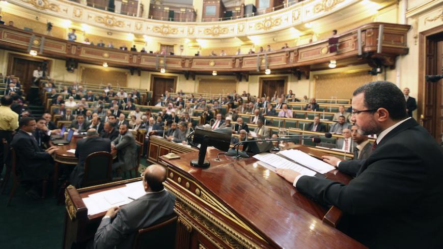 Egypt's Prime Minister Hisham Qandil (R) talks during a session of the upper house of the parliament in Cairo, on a dam being built by Ethiopia, June 10, 2013. Egypt's President Mohamed Mursi said on Monday he would keep "all options" open to defend Egypt's water supply from being affected by the giant new dam Ethiopia is building on the Nile but he added that Cairo did not want war. REUTERS/Mohamed Abd El Ghany (EGYPT - Tags: POLITICS ENVIRONMENT ENERGY) - RTX10J0J