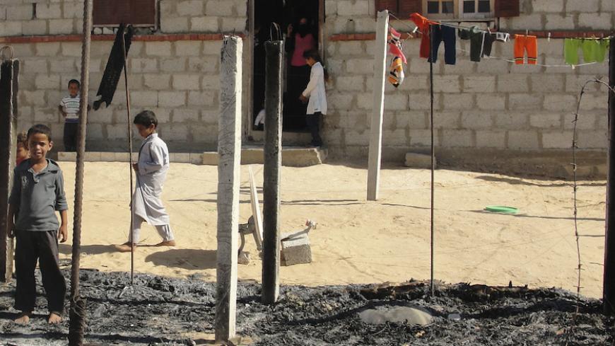 Boys look at a burnt area around a house after assaults on militant targets by the Egyptian Army, in a village on the outskirts of Sheikh Zuweid, near the city of El-Arish in Egypt's Sinai peninsula September 10, 2013. Egypt has tightened control of crossings from the Sinai peninsula and continued assaults on militants after an Islamist group based there said it tried to kill the interior minister in Cairo last week, the state news agency reported on Monday. REUTERS/Stringer  (EGYPT - Tags: POLITICS CIVIL U