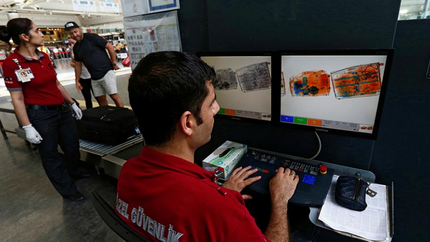 Security officers work on an x-ray machine at Turkey's largest airport, Istanbul Ataturk, following yesterday's blast June 29, 2016. REUTERS/Murad Sezer TPX IMAGES OF THE DAY - RTX2ITZ4
