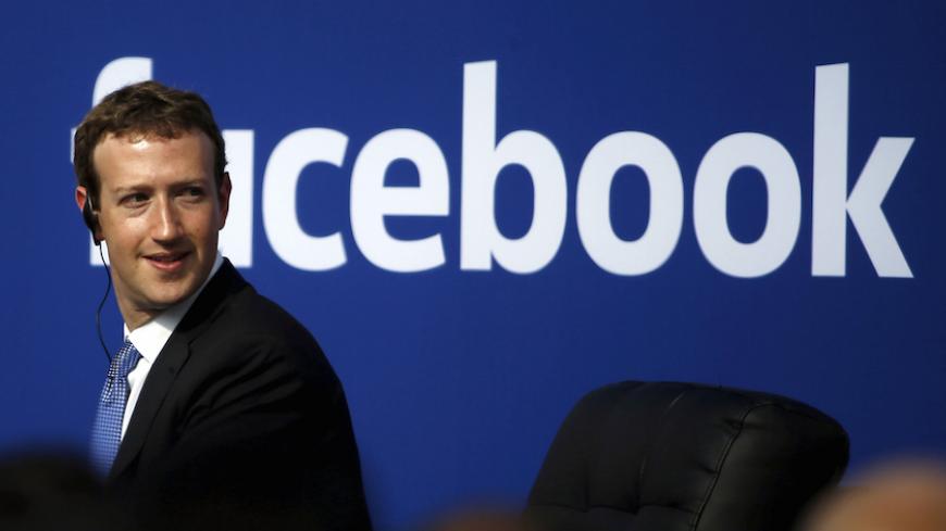 Facebook CEO Mark Zuckerberg is seen on stage during a town hall at Facebook's headquarters in Menlo Park, California September 27, 2015. Picture taken February 27, 2015.  REUTERS/Stephen Lam/File Photo - RTX2K5PB