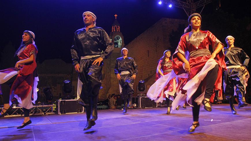 Palestinian dancers perform during celebrations in front of the Church of the Nativity, the traditional birthplace of Jesus Christ, in the biblical West Bank town of Bethlehem on July 7, 2012, a week after the UN cultural body UNESCO overrode Israeli objections to urgently grant world heritage status to the ancient church.  AFP PHOTO/MUSA AL-SHAER        (Photo credit should read MUSA AL-SHAER/AFP/GettyImages)