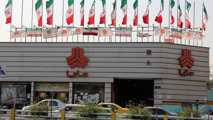 TO GO WITH AFP STORY BY ALI NOORANI - A picture taken on September 12, 2015 shows cars driving past a sales office of Iranian auto manufacturer SAIPA group in the capital Tehran. A campaign to boycott "substandard and expensive" Iranian-made cars has fired up social media in the Islamic republic, where its supporters have been accused of anti-revolutionary treason.   AFP PHOTO / ATTA KENARE        (Photo credit should read ATTA KENARE/AFP/Getty Images)