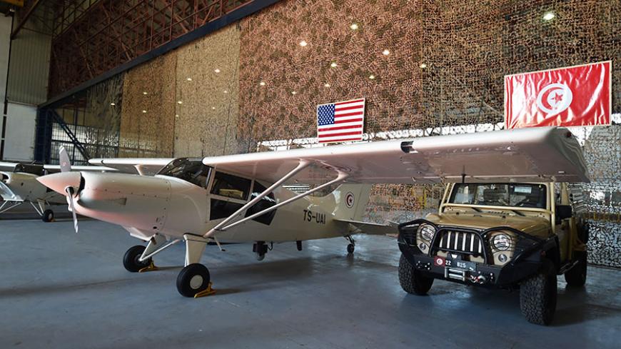 Reconnaissance aircrafts and military vehicles offered to Tunisia by the United States are seen at a military base in Tunis on May 12, 2016.
The United States delivered military hardware to Tunisia to help the North African country hit by several Islamic State group attacks secure its borders and battle terrorism. The US deputy assistant secretary of defence for African affairs, said the military equipment was part of a $20 million package destined to bolster Tunisia's military capabilities.



 / AFP / FET