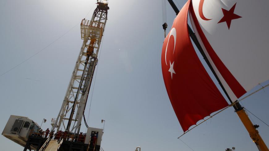 Turkish and Turkish Cypriot flags wave next to a drilling tower 25 km (16 miles) from Famagusta April 26, 2012. Turkish Cypriot Leader Dervis Eroglu and Turkey's Energy Minister Taner Yildiz attended a ceremony marking the start of joint gas and oil exploration works in northern Cyprus between Turkey's state-owned energy company TPAO and the Turkish-Cypriot administration. REUTERS/Umit Bektas (CYPRUS - Tags: POLITICS ENERGY BUSINESS) - RTR318P7