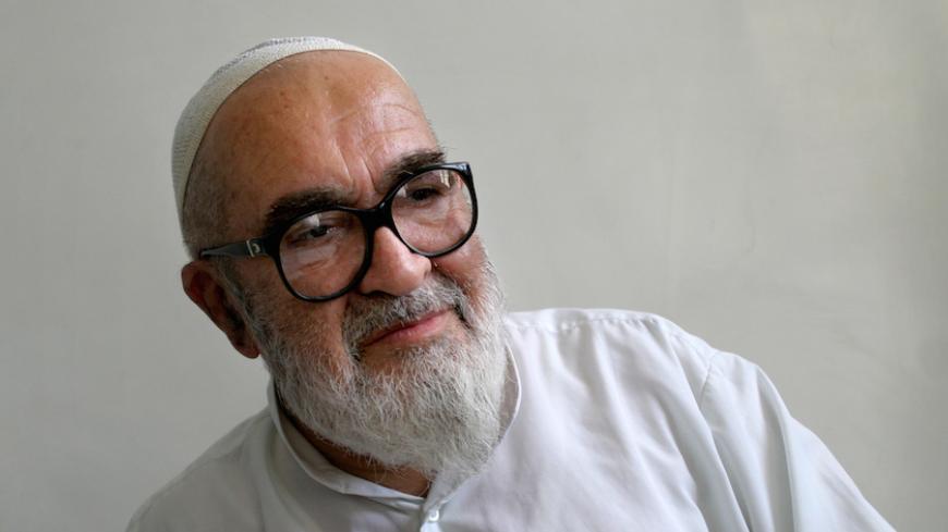 Iranian dissident cleric Grand Ayatollah Hossein Ali Montazeri speaks with Reuters at his home in Qom, 120 km (75 miles) south of Tehran, May 19, 2005. Iran's Islamic system has been abused to deny the president real power, sapping public interest in next month's election, Montazeri told Reuters. Picture taken May 19, 2005. REUTERS/Morteza Nikoubazl  MN/DY/TZ - RTRBTXJ