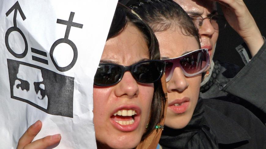 Iranian women take part in a protest in front of the Tehran University in Tehran June 12, 2005. About 300 women took part in the protest against gender discrimination in the Islamic republic of Iran. REUTERS/Raheb Homavandi PJH - RTRE6DE