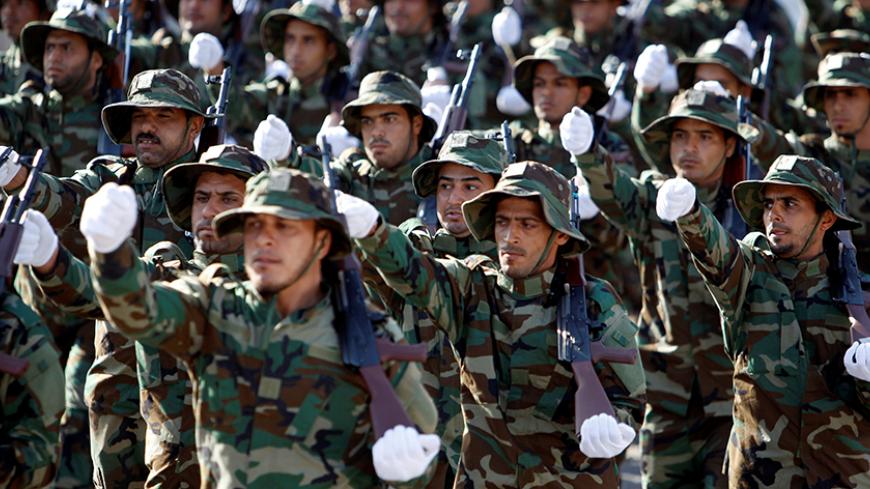 Shi’ite paramilitary groups known as Hashid Shaabi (Popular Mobilisation) take part in a military parade at Tahrir Square in central Baghdad, Iraq, July 14, 2016. REUTERS/Khalid al Mousily - RTSHU3N
