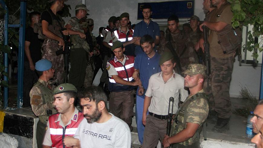 Turkish gendarmeries escort fugitive commandos who were involved in a bid to seize President Tayyip Erdogan during a failed coup attempt last month, as they leave from a gendarmerie station in Mugla province, Turkey, early August 1, 2016. REUTERS/Kenan Gurbuz - RTSKIP4