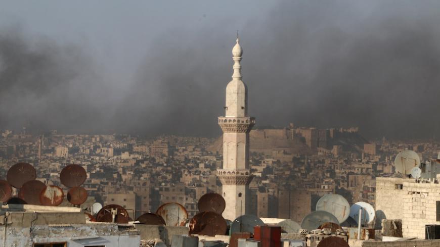 A general view shows rising smoke from burning tyres, which activists said are used to create smoke cover from warplanes, in Aleppo, Syria  August 1, 2016. REUTERS/Abdalrhman Ismail - RTSKLMM