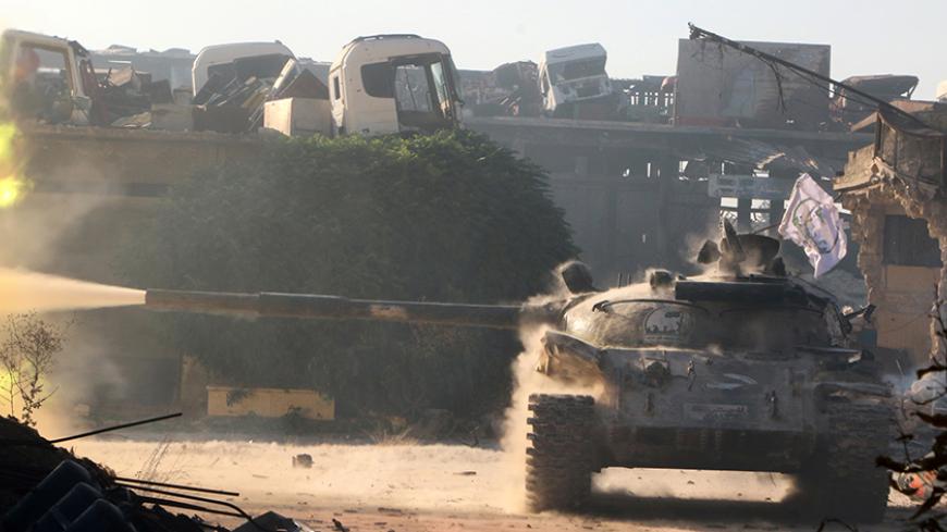A Free Syrian Army tank fires in Ramousah area, southwest of Aleppo, Syria August 2, 2016. Picture taken August 2, 2016. REUTERS/Abdalrhman Ismail - RTSKU1N