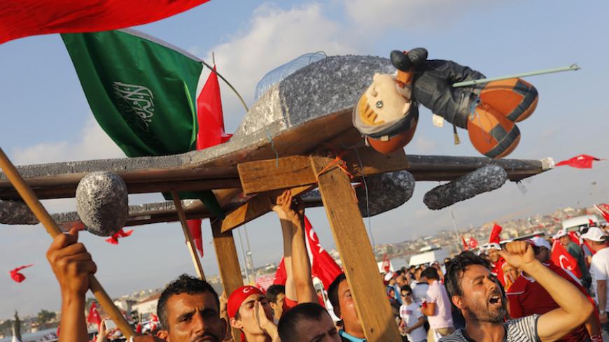 People hold a plane model with attached toy, depicting oposition cleric in exile Fethullah Gulen, during the Democracy and Martyrs Rally, organized by Turkish President Tayyip Erdogan and supported by ruling AK Party (AKP), oppositions Republican People's Party (CHP) and Nationalist Movement Party (MHP), to protest against last month's failed military coup attempt, in Istanbul, Turkey, August 7, 2016. REUTERS/Umit Bektas - RTSLL8O