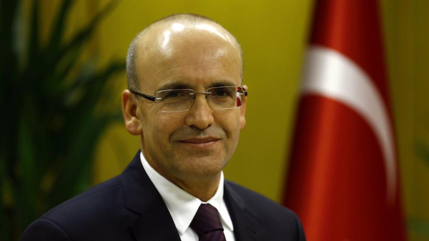 Turkish Deputy Prime Minister Mehmet Simsek poses during an interview with Reuters in Ankara, Turkey, December 23, 2015. Simsek said he expects gross domestic product to grow a higher-than-expected 3.5-4 percent this year and sees growth next year above the official 4 percent forecast. Picture taken December 23, 2015. To match Interview TURKEY-ECONOMY/SIMSEK REUTERS/Umit Bektas - RTX1ZZ1V