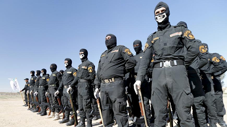 Iraqi Sunni Muslim fighters from Hashid Shaabi (Popular Mobilization) take part in a parade during a ceremony marking the Iraqi Police Day at Amiriyat al-Fallujah in Anbar province, January 9, 2016. REUTERS/Thaier Al-Sudani - RTX21NI3
