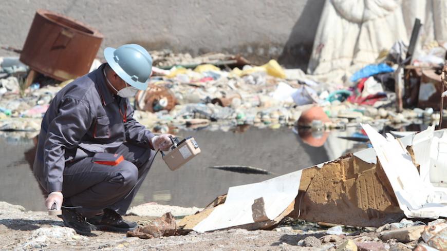 A member of a counter-radiation team uses a Geiger counter to search for missing radioactive material in Basra, Iraq, February 21, 2016. Radioactive material that went missing in Iraq has been found dumped near a petrol station in the southern town of Zubair, officials said on Sunday, ending speculation it could be acquired by Islamic State and used as a weapon. The officials told Reuters the material, stored in a protective case the size of a laptop computer, was undamaged and there were no concerns about 
