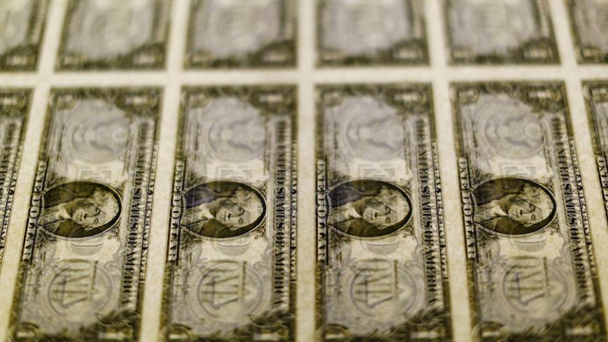 United States one dollar bills are seen on a light table at the Bureau of Engraving and Printing in Washington November 14, 2014. REUTERS/Gary Cameron/File Photo GLOBAL BUSINESS WEEK AHEAD PACKAGE – SEARCH “BUSINESS WEEK AHEAD JUNE 13” FOR ALL IMAGES - RTX2FV2B