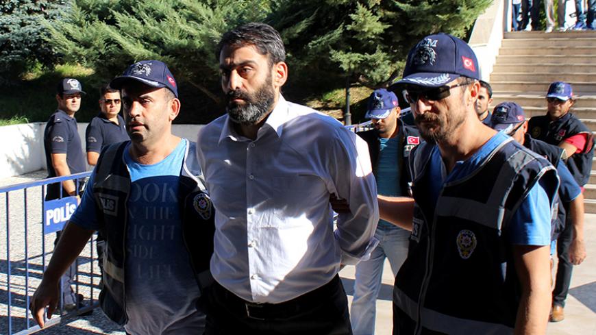 Major Sukru Seymen (C), one of the military personnel suspected of being involved in the coup attempt, is brought to a court house as he is accompanied by police officers and other detaniees in Mugla, Turkey, August 17, 2016. REUTERS/Kenan Gurbuz     TPX IMAGES OF THE DAY      - RTX2LGHG