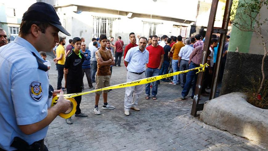 A police officer secures the scene of an explosion where a suspected suicide bomber targeted a wedding celebration in the Turkish city of Gaziantep, Turkey, August 21, 2016. REUTERS/Osman Orsal - RTX2MECV