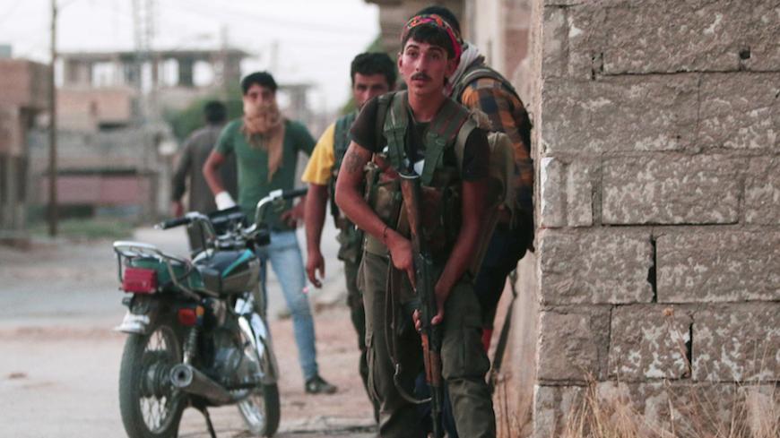 Kurdish fighters from the People's Protection Units (YPG) carry their weapons as they take positions in the northeastern city of Hasaka, Syria, August 20, 2016. Picture taken August 20, 2016. REUTERS/Rodi Said     TPX IMAGES OF THE DAY      - RTX2MEE9