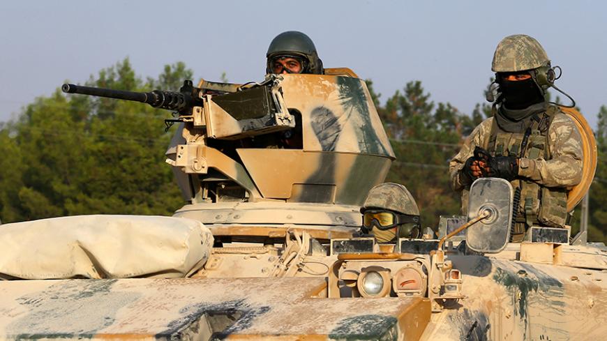 Turkish soldiers on an armoured personnel carrier drive towards the border in Karkamis on the Turkish-Syrian border in the southeastern Gaziantep province, Turkey, August 27, 2016. REUTERS/Umit Bektas  - RTX2N8HY
