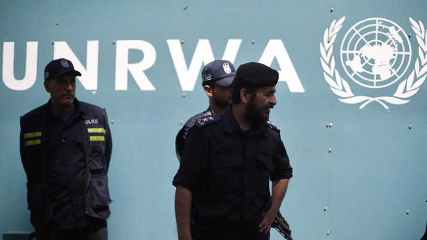 Palestinian policemen loyal to Hamas guard outside the United Nations Relief and Works Agency (UNRWA) headquarters during a protest demanding to resume financial aid for refugees, in Gaza City April 15, 2013. Robert Turner, UNRWA's director of Gaza operations, said the agency faced a $68 million shortfall in 2013 and that it had decided to cut a $40 annual handout to 106,000 Gaza refugees to save some $5.5 million. To soften the blow, the agency offered job programmes to help the poorest families. REUTERS/M