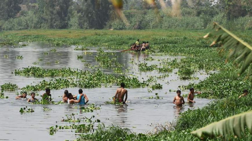 Egyptians take a dip in one of the branches of the Nile in the Menufiya district, north of the capital Cairo, on May 2, 2016, as they celebrate Sham al-Nessim, a Pharaonic feast that marks the start of spring.
/ AFP / MOHAMED EL-SHAHED (Photo credit should read MOHAMED EL-SHAHED/AFP/Getty Images)