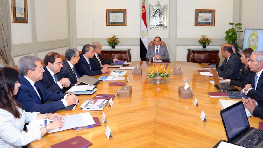Egyptian President Abdel Fattah al-Sisi (C) attends a meeting with Egypt's Prime Minister Sherif Ismail and members of the government's Economic Ministerial Committee to discuss future economic indicators and figures of the general budget and the results of the talks with the International Monetary Fund (IMF) at the Ittihadiya presidential palace in Cairo, Egypt July 27, 2016 in this handout picture courtesy of the Egyptian Presidency. The Egyptian Presidency/Handout via REUTERS ATTENTION EDITORS - THIS IMA