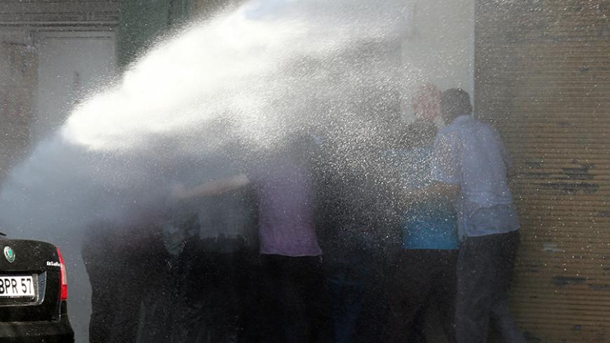 Turkish riot police use water cannon to disperse Kurdish demonstrators protesting against the removal of the local mayor from office over suspected links with Kurdish militants, in Diyarbakir, Turkey, September 11, 2016. REUTERS/Sertac Kayar TPX IMAGES OF THE DAY      - RTSN88G