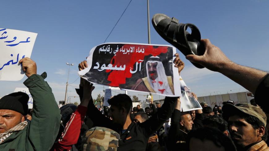 Supporters of Shi'ite cleric Moqtada al-Sadr protest against the execution of Shi'ite Muslim cleric Nimr al-Nimr in Saudi Arabia, during a demonstration in Baghdad January 4, 2016. The poster reads, "Innocent blood on your hands, Al-Saud". REUTERS/Thaier Al-Sudani - RTX20ZAD