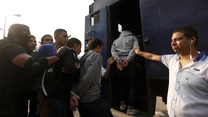 FILE PHOTO: Police detain students at Al-Azhar University after student protests in Cairo, Egypt, October 30, 2013. To match Special Report EGYPT-STUDENTS/    REUTERS/Staff/File Photo  - RTX2F3P8