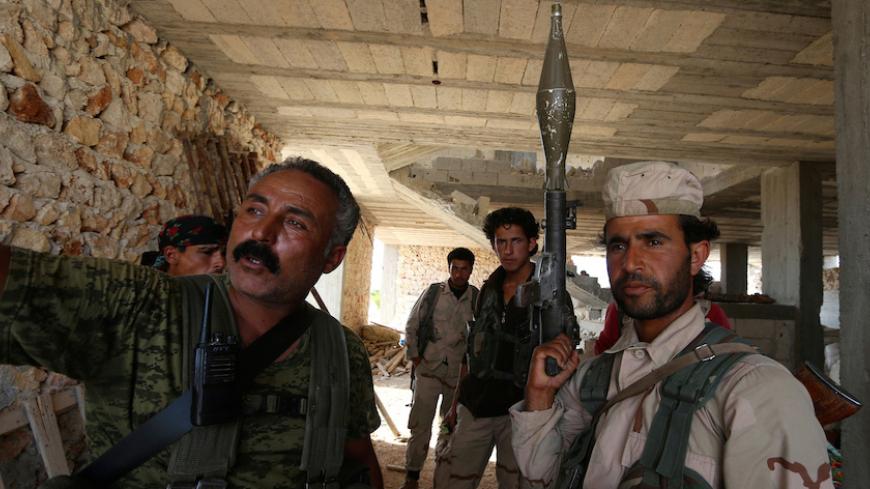 Fighters of the Syria Democratic Forces (SDF) stand inside a building near Manbij, in Aleppo Governorate, Syria, June 17, 2016.  REUTERS/Rodi Said/File Photo - RTX2HMHI