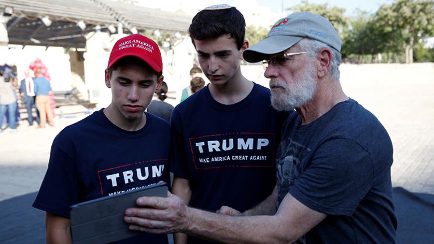 Israeli American Sruly Cooper(R) signs to vote in the US elections in front of members of the U.S. Republican party's election campaign team in Israel during a campaign aimed at potential American voters living in Israel, near a mall in Modi'in, Israel August 15, 2016. REUTERS/Baz Ratner - RTX2KZVI