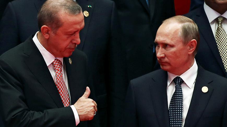 Russia's President Vladimir Putin interacts with Turkey's President Tayyip Erdogan as they pose for a group picture during the G20 Summit in Hangzhou, Zhejiang province, China September 4, 2016. REUTERS/Damir Sagolj      TPX IMAGES OF THE DAY      - RTX2O1GI