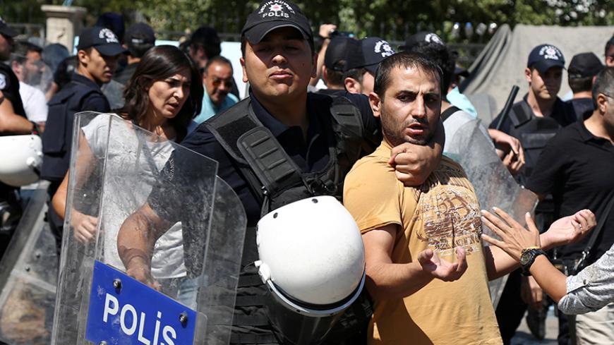 Riot police detain a demonstrator during a protest against the suspension of teachers from classrooms over alleged links with Kurdish militants, in the southeastern city of Diyarbakir, Turkey, September 9, 2016. REUTERS/Sertac Kayar - RTX2OUAU