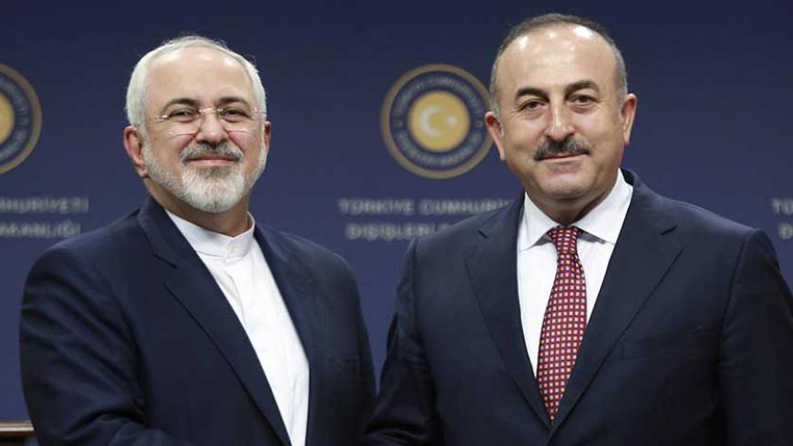 Turkish Foreign Minister Mevlut Cavusoglu (R) and Iran's Foreign Minister Mohammad Javad Zarif shake hands following a joint press conference at the Foreign Ministry in Ankara on August 12, 2016. / AFP / ADEM ALTAN (Photo credit should read ADEM ALTAN/AFP/Getty Images)