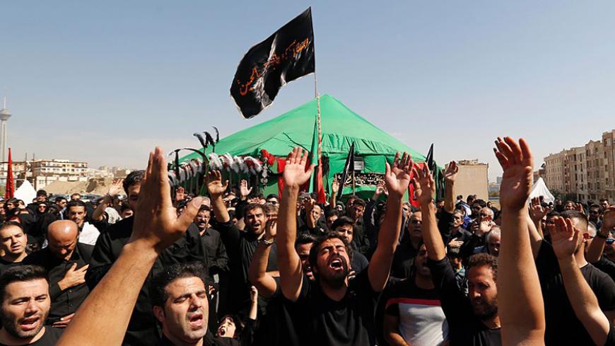 Iranian Shiite Muslims chant in western Tehran on October 12, 2016, during the annual Ashura commemorations marking the killing of Imam Hussein, the grandson of Islam's Prophet Mohammed in 680AD.  / AFP / ATTA KENARE        (Photo credit should read ATTA KENARE/AFP/Getty Images)