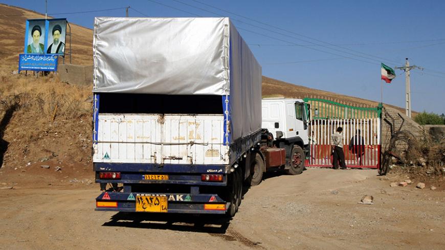 Iranian trucks wait to return to Iran through the Iraq-Iran border crossing of Haj Omran 25 September 2007.  Iran's sudden closure of its border with northern Iraq caused trucking chaos at the frontier today, as experts warned of severe economic fallout and traders scrambled for goods. Tehran said yesterday it was closing its frontier with Iraq's autonomous Kurdish region in protest at the detention last week of an Iranian by US troops. AFP PHOTO/SAFIN HAMED (Photo credit should read SAFIN HAMED/AFP/Getty I