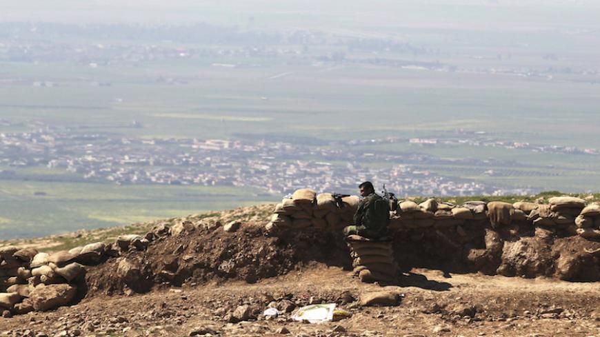 A member of the Kurdish Peshmerga forces guards a security point on Bashiqa mountain, overlooking Islamic State held territories of Mosul, 12 km northeast of Mosul City, March 7, 2015. REUTERS/Asmaa Waguih (IRAQ - Tags: POLITICS MILITARY CONFLICT) - RTR4SF1D