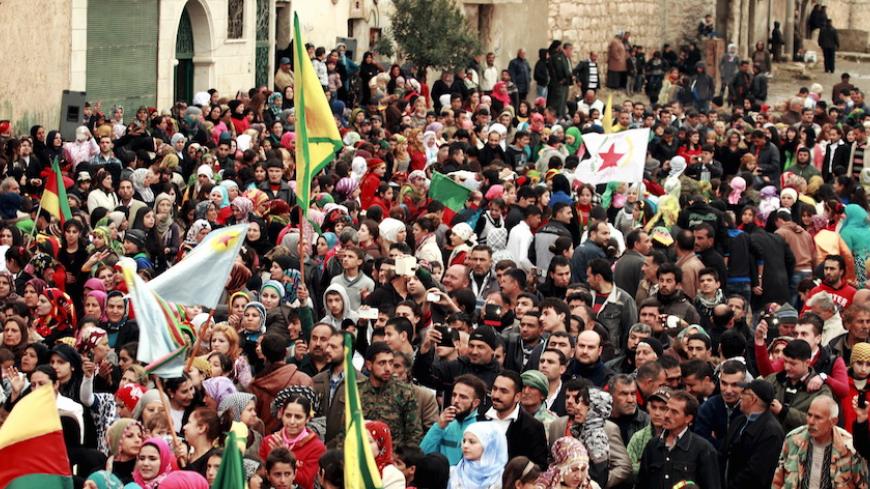 Kurds carry Kurdish flags during a gathering to celebrate Newroz, which marks the arrival of spring and the new year, in the Sheikh Maksoud neighbourhood of Aleppo March 21, 2015.  REUTERS/Ammar Abdullah - RTR4UBTE