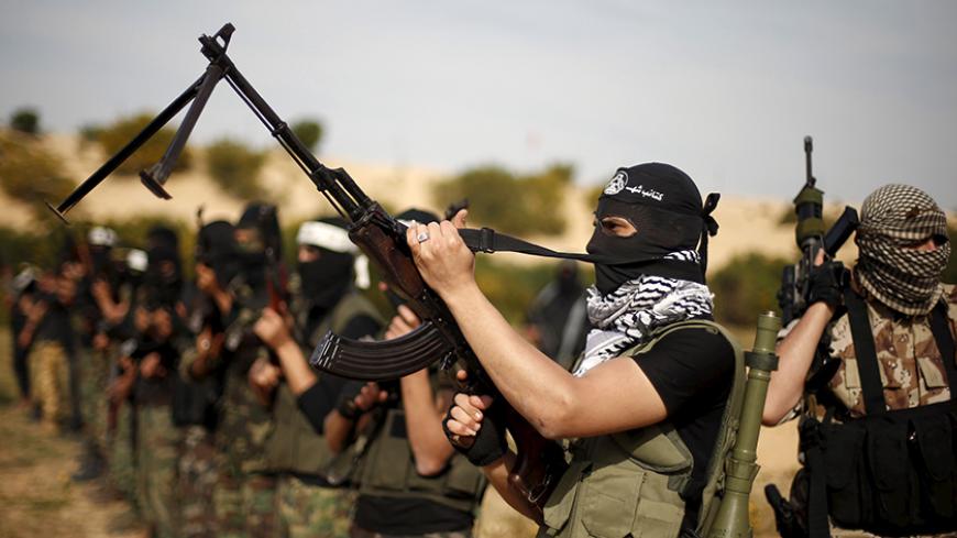 Masked Palestinian militants from the al-Aqsa Martyrs Brigades, the armed wing of the Fatah movement,  take part in an anti-Israel military drill in Rafah in the southern Gaza Strip March 25, 2015.  REUTERS/Suhaib Salem
 - RTR4UUET