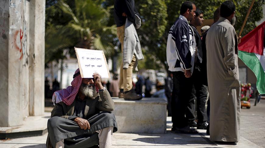 A Palestinian man rests as other take part in a protest calling for a better living condition for people, in Gaza city April 2, 2016. REUTERS/Suhaib Salem  - RTSD8M3